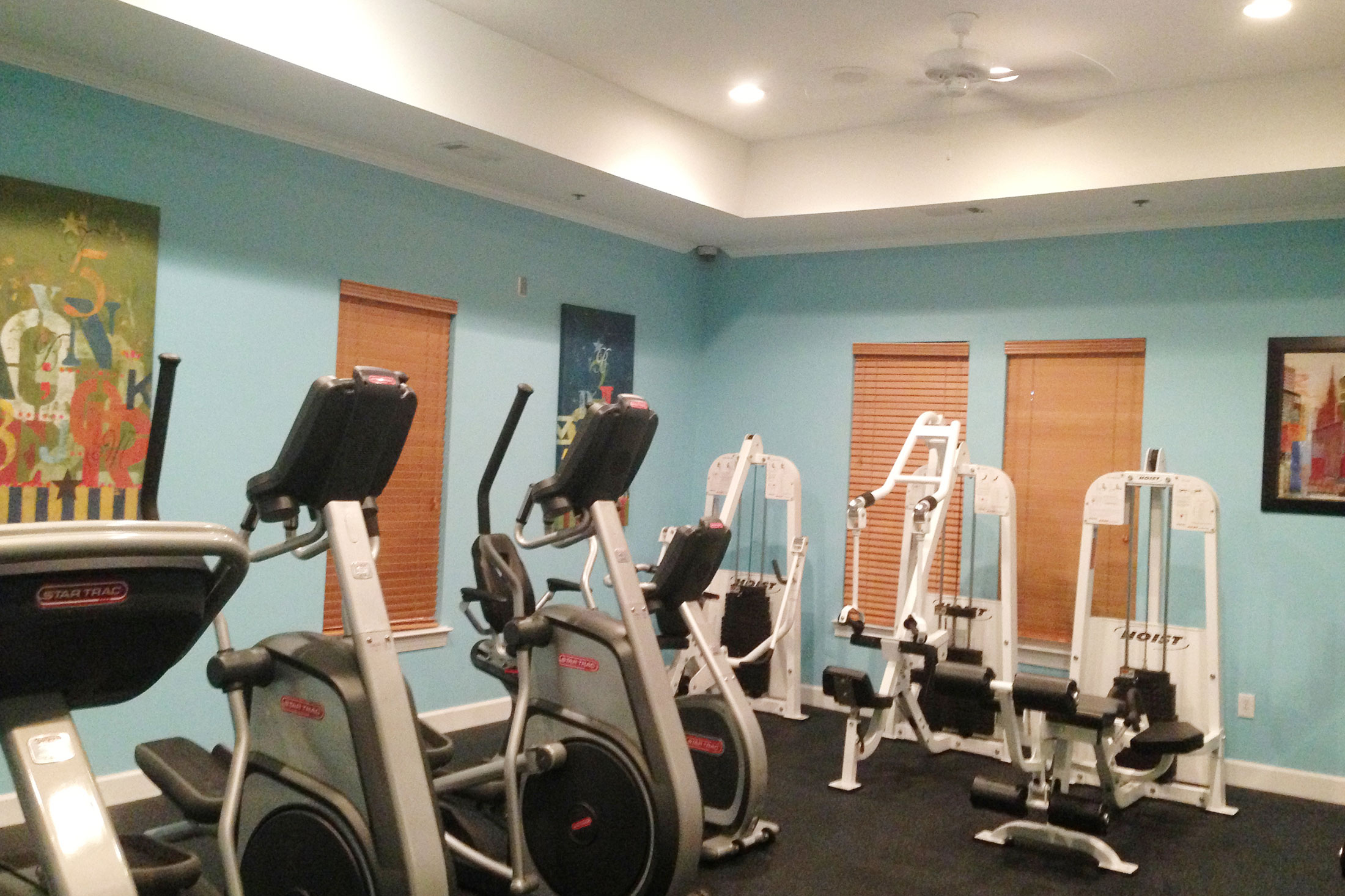 Fitness center with treadmills, elliptical machines, and weight lifting machines.